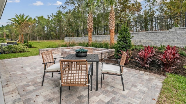 view of patio with outdoor dining space and fence
