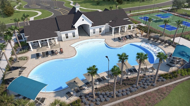 community pool featuring fence and a patio area
