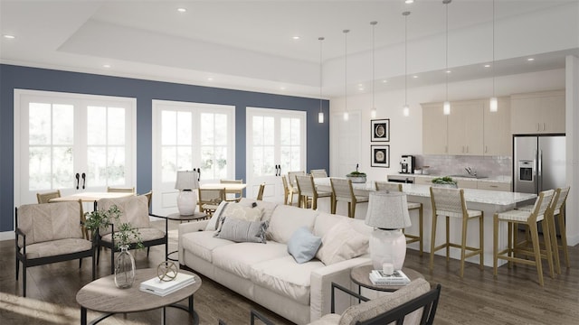 living room with dark wood-style floors, recessed lighting, and a raised ceiling