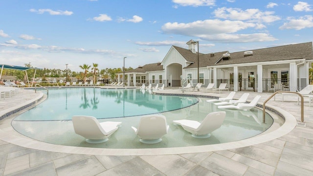 community pool with a patio area and french doors
