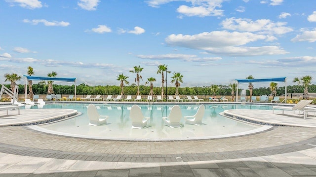 community pool with fence and a patio
