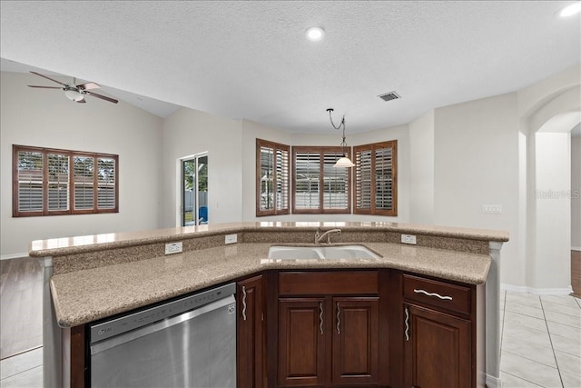 100 Point Pleasant Dr, Palm Coast, FL 32164 - kitchen with stainless steel dishwasher, a sink, a ceiling fan, baseboards, and a textured ceiling