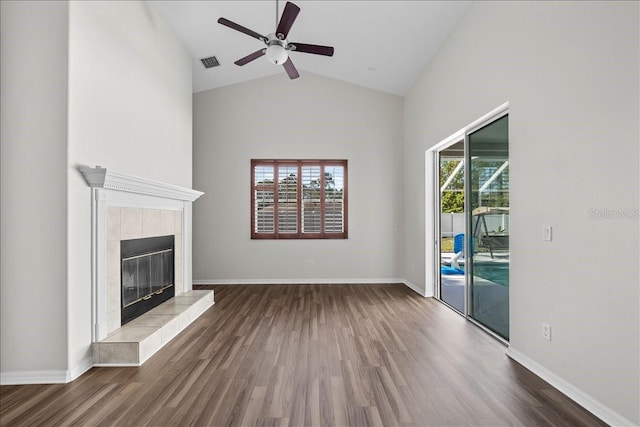 100 Point Pleasant Dr, Palm Coast, FL 32164 - unfurnished living room featuring wood finished floors, ceiling fan, high vaulted ceiling, and a tiled fireplace