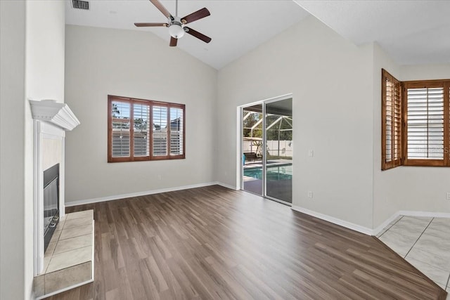 100 Point Pleasant Dr, Palm Coast, FL 32164 - unfurnished living room with ceiling fan, healthy amount of natural light, wood finished floors, and high vaulted ceiling