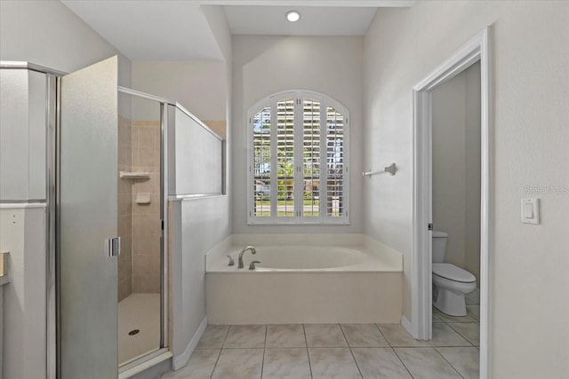 100 Point Pleasant Dr, Palm Coast, FL 32164 - bathroom with a garden tub, toilet, a shower stall, tile patterned floors, and baseboards