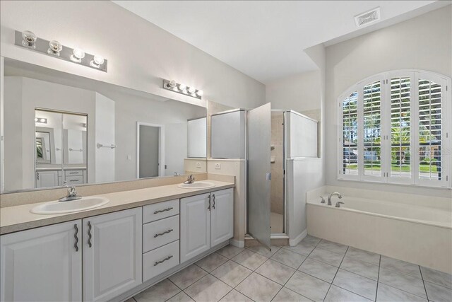 100 Point Pleasant Dr, Palm Coast, FL 32164 - full bath featuring a shower stall, double vanity, a garden tub, and tile patterned floors