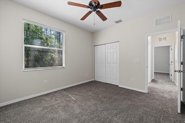 100 Point Pleasant Dr, Palm Coast, FL 32164 - unfurnished bedroom featuring carpet floors, a closet, baseboards, and ceiling fan