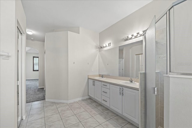 100 Point Pleasant Dr, Palm Coast, FL 32164 - full bathroom featuring double vanity, tile patterned flooring, a shower stall, and baseboards