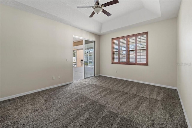 100 Point Pleasant Dr, Palm Coast, FL 32164 - unfurnished room featuring a ceiling fan, carpet, baseboards, and a tray ceiling