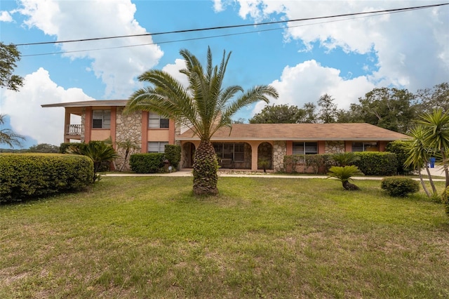 5009 Shore Dr, Saint Augustine, FL 32086 - view of front facade featuring stone siding, a front lawn, and stucco siding