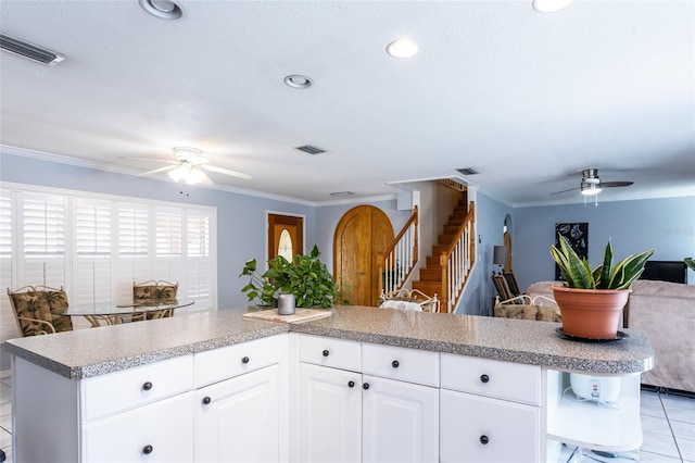 5009 Shore Dr, Saint Augustine, FL 32086 - kitchen featuring a ceiling fan, open shelves, open floor plan, crown molding, and light countertops