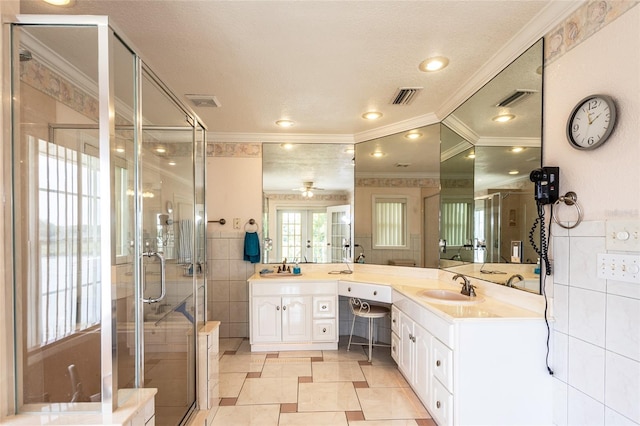 5009 Shore Dr, Saint Augustine, FL 32086 - bathroom featuring crown molding, double vanity, a shower stall, tile walls, and a ceiling fan