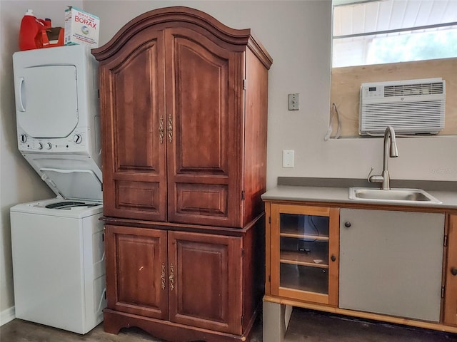 5009 Shore Dr, Saint Augustine, FL 32086 - laundry area featuring stacked washer and clothes dryer, cabinet space, and a wall unit AC