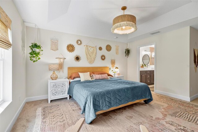 40 Biscayne Dr, Palm Coast, FL 32137 - bedroom with baseboards, ensuite bath, and light colored carpet