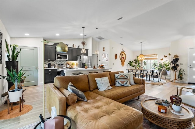 40 Biscayne Dr, Palm Coast, FL 32137 - living room featuring light wood-type flooring and vaulted ceiling
