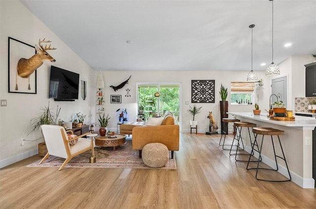 40 Biscayne Dr, Palm Coast, FL 32137 - living room with plenty of natural light, light wood finished floors, and baseboards