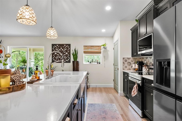 40 Biscayne Dr, Palm Coast, FL 32137 - kitchen featuring appliances with stainless steel finishes, healthy amount of natural light, light countertops, light wood finished floors, and recessed lighting