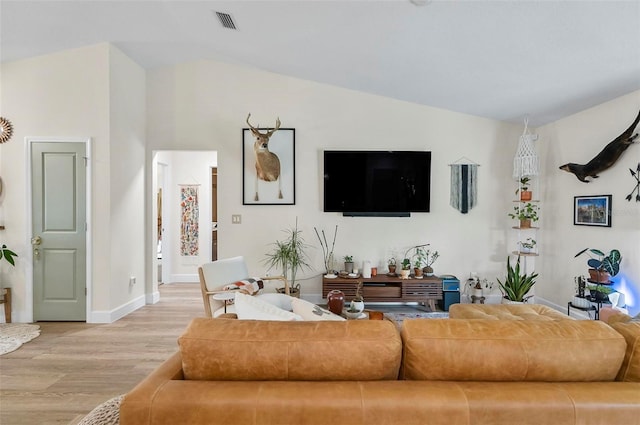 40 Biscayne Dr, Palm Coast, FL 32137 - living room with light wood-type flooring, vaulted ceiling, and baseboards