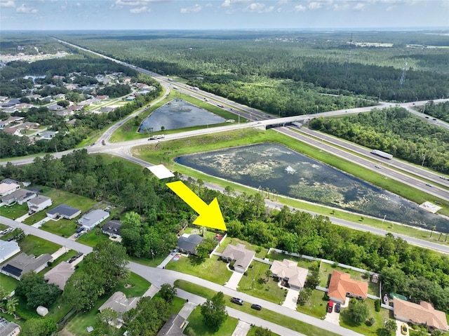 40 Biscayne Dr, Palm Coast, FL 32137 - aerial view of property and surrounding area with a forest, a nearby body of water, and nearby suburban area