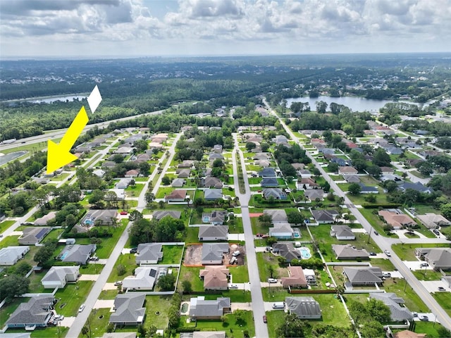 40 Biscayne Dr, Palm Coast, FL 32137 - aerial overview of property's location with a nearby body of water, nearby suburban area, property parcel outlined, and a heavily wooded area
