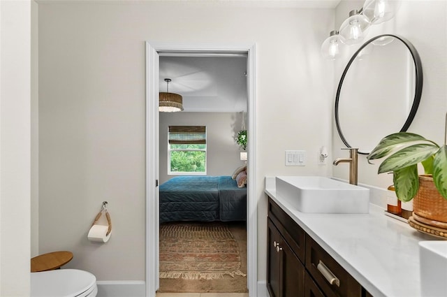 40 Biscayne Dr, Palm Coast, FL 32137 - ensuite bathroom featuring vanity, toilet, and baseboards
