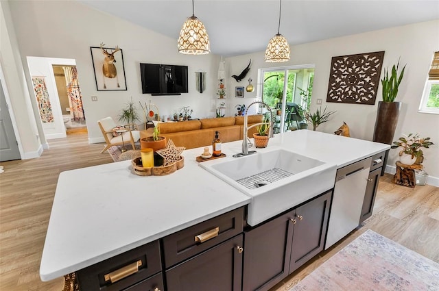 40 Biscayne Dr, Palm Coast, FL 32137 - kitchen featuring dishwasher, baseboards, light wood-style flooring, a sink, and decorative light fixtures