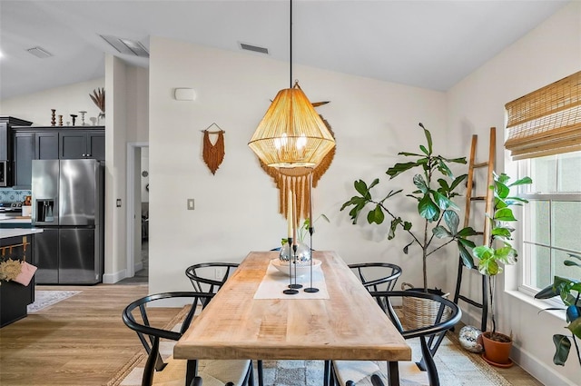 40 Biscayne Dr, Palm Coast, FL 32137 - dining area featuring light wood finished floors, plenty of natural light, lofted ceiling, and baseboards