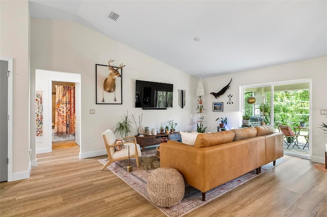 40 Biscayne Dr, Palm Coast, FL 32137 - living area featuring light wood finished floors, lofted ceiling, and baseboards