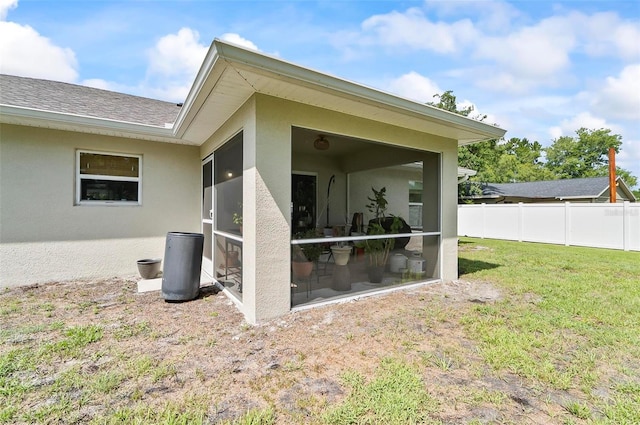 40 Biscayne Dr, Palm Coast, FL 32137 - view of property exterior with stucco siding and a sunroom