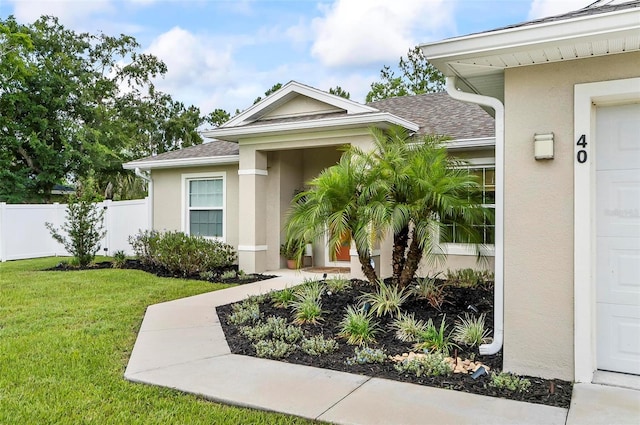 40 Biscayne Dr, Palm Coast, FL 32137 - doorway to property featuring stucco siding and roof with shingles