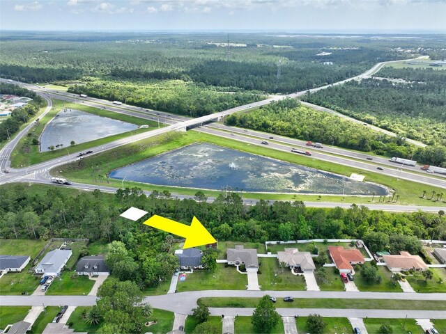 40 Biscayne Dr, Palm Coast, FL 32137 - view of property location featuring a heavily wooded area, a nearby body of water, and nearby suburban area