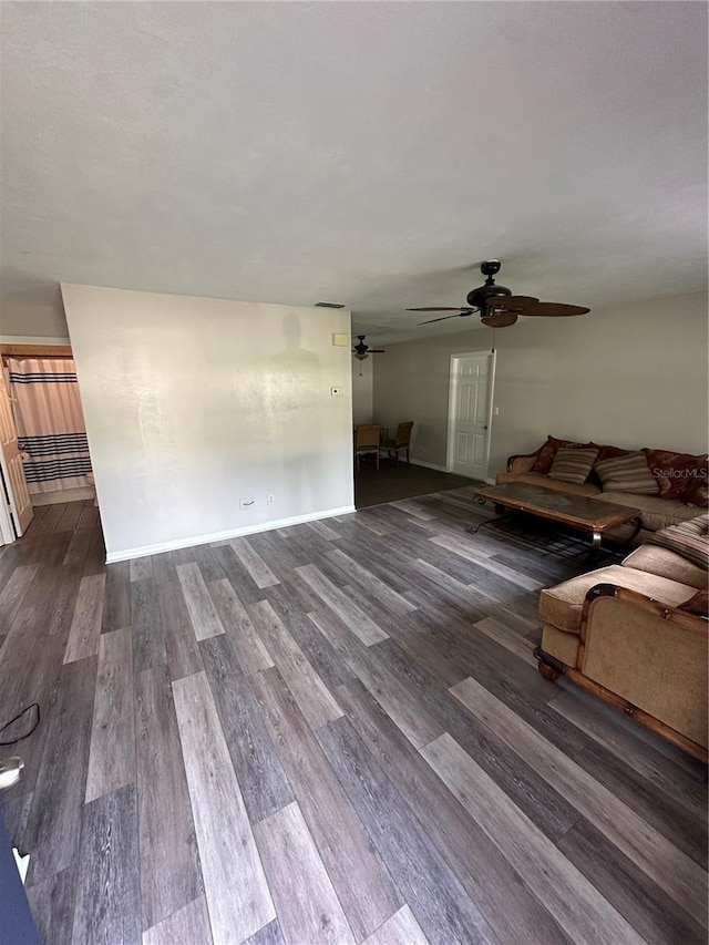 4 Sleepy Hollow Trl, Palm Coast, FL 32164 - unfurnished living room with ceiling fan, dark wood-style flooring, and baseboards