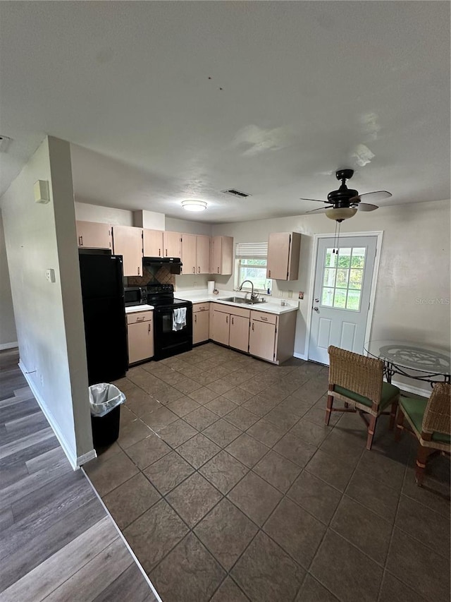4 Sleepy Hollow Trl, Palm Coast, FL 32164 - kitchen with black appliances, a sink, light countertops, under cabinet range hood, and ceiling fan