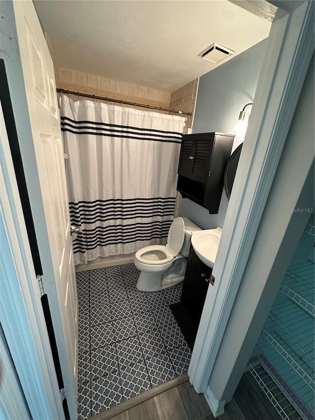 4 Sleepy Hollow Trl, Palm Coast, FL 32164 - full bathroom featuring toilet, vanity, and wood finished floors
