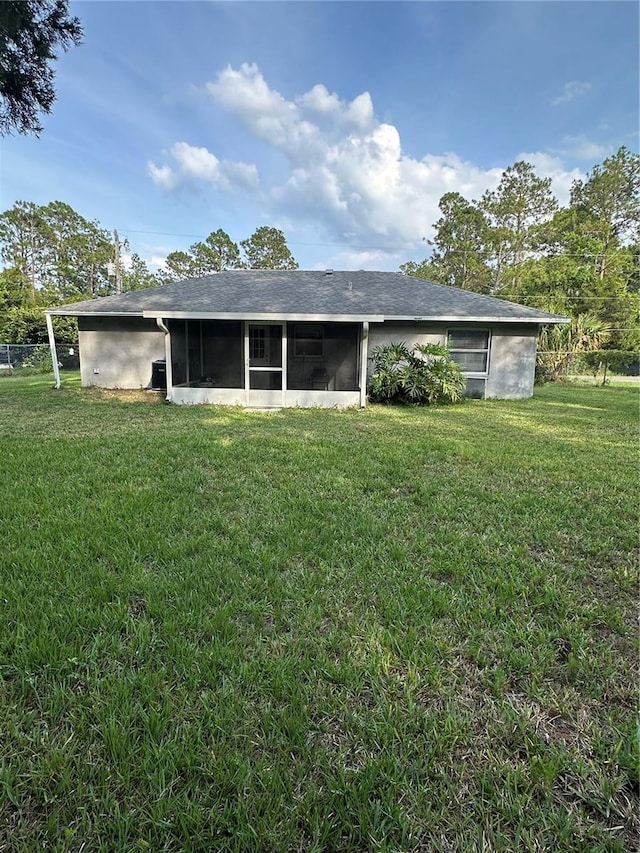 4 Sleepy Hollow Trl, Palm Coast, FL 32164 - rear view of house featuring a sunroom and a lawn