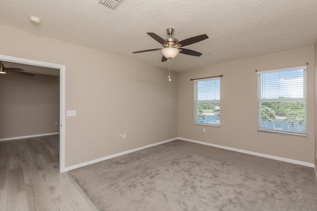 600 Canopy Walk Ln Unit 634, Palm Coast, FL 32137 - empty room with a ceiling fan, baseboards, a smoke detector, a textured ceiling, and light wood finished floors