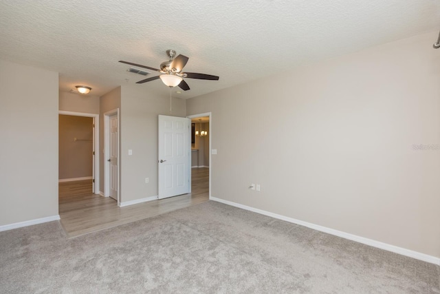600 Canopy Walk Ln Unit 634, Palm Coast, FL 32137 - unfurnished bedroom with light colored carpet, baseboards, a textured ceiling, and ceiling fan