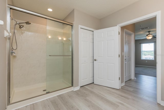 600 Canopy Walk Ln Unit 634, Palm Coast, FL 32137 - bathroom with a shower stall, wood finished floors, baseboards, and a ceiling fan