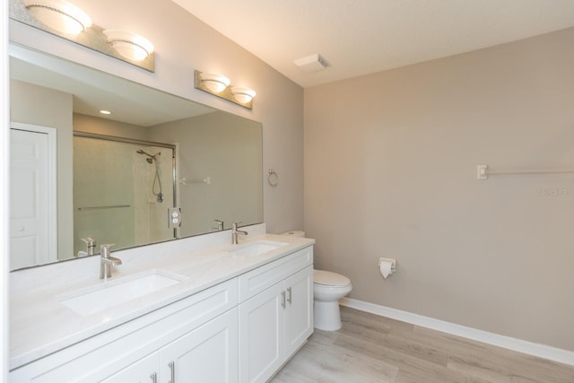 600 Canopy Walk Ln Unit 634, Palm Coast, FL 32137 - full bath with toilet, a stall shower, double vanity, wood finished floors, and baseboards