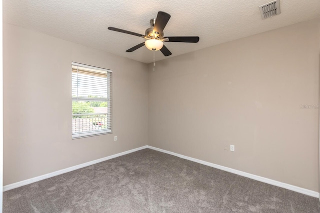 600 Canopy Walk Ln Unit 634, Palm Coast, FL 32137 - spare room featuring dark colored carpet, baseboards, a ceiling fan, and a textured ceiling