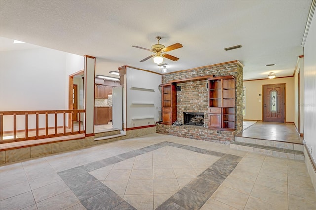 1466 Arena Rd, Fleming Island, FL 32003 - unfurnished living room featuring ceiling fan, light tile patterned flooring, a brick fireplace, a textured ceiling, and crown molding