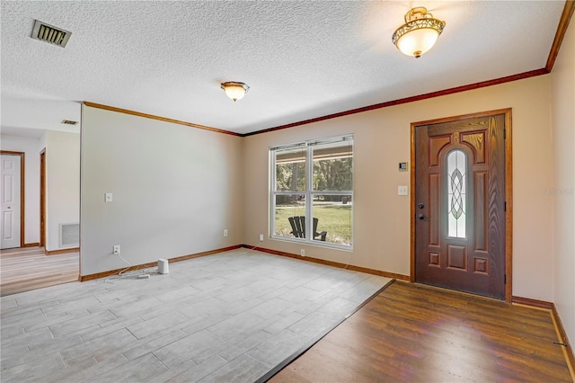 1466 Arena Rd, Fleming Island, FL 32003 - foyer featuring light wood finished floors, crown molding, baseboards, and a textured ceiling