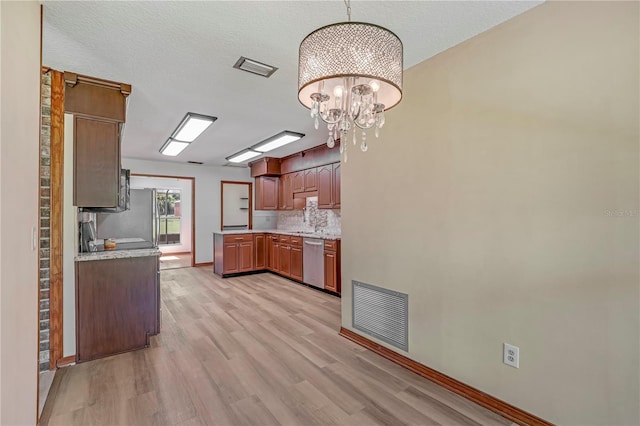1466 Arena Rd, Fleming Island, FL 32003 - kitchen featuring stainless steel dishwasher, light wood-type flooring, a chandelier, and light countertops