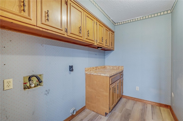 1466 Arena Rd, Fleming Island, FL 32003 - laundry room featuring cabinet space, hookup for a washing machine, light wood-style floors, hookup for an electric dryer, and baseboards