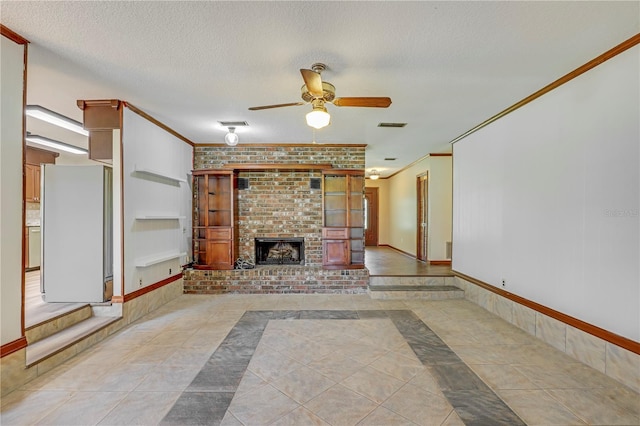 1466 Arena Rd, Fleming Island, FL 32003 - unfurnished living room featuring a ceiling fan, tile patterned floors, a brick fireplace, a textured ceiling, and inlaid floor details