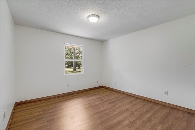 1466 Arena Rd, Fleming Island, FL 32003 - spare room with wood finished floors, baseboards, and a textured ceiling