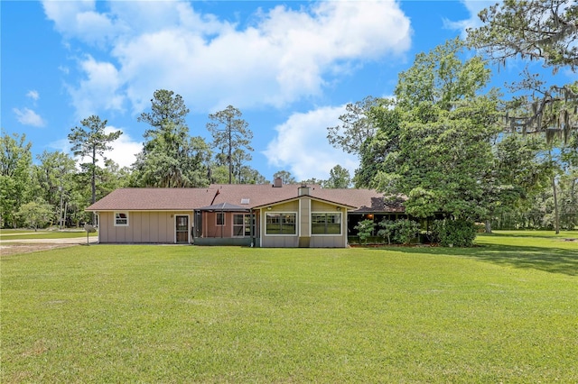 1466 Arena Rd, Fleming Island, FL 32003 - back of property featuring a lawn, board and batten siding, and a shingled roof