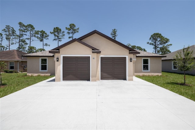 47 Providence Ln, Palm Coast, FL 32164 - ranch-style home featuring concrete driveway, stucco siding, a garage, and a front lawn
