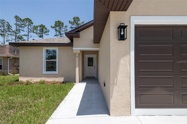 47 Providence Ln, Palm Coast, FL 32164 - entrance to property with stucco siding and a garage