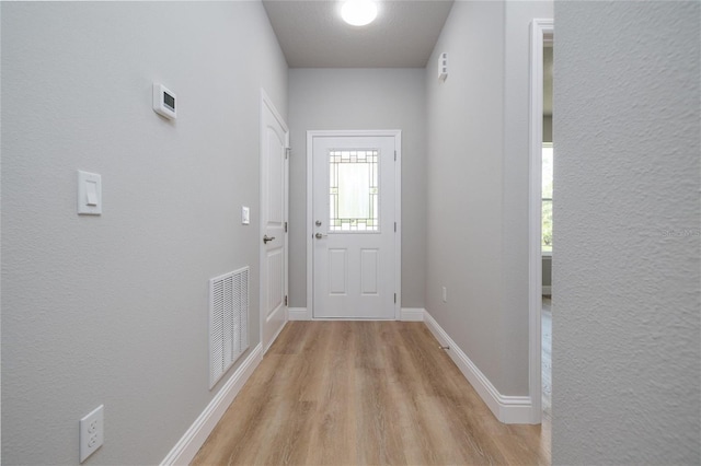 47 Providence Ln, Palm Coast, FL 32164 - doorway to outside featuring light wood-style flooring and baseboards